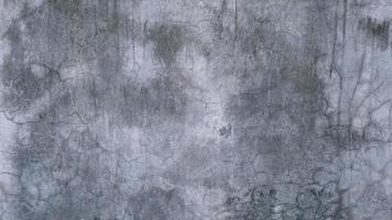The old cement wall was weathered, the surface was scratched, the surface was scratched and damaged. For a mysterious retro-conservative background. photo