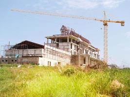 The building under construction overlooking the sky and clouds. photo