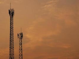 Two Telecom cell phone or telecommunication masts with blue sky backdrop, telecom tower for background uses. photo