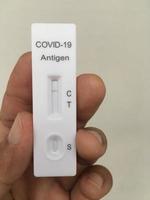 Close-up of hand holding COVID-19 test tool negative coronavirus test Covid-19 test kit for detecting IgM IgG antibodies and immunity spot focus photo