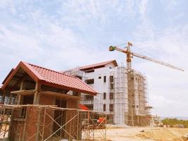 The building under construction overlooking the sky and clouds. photo