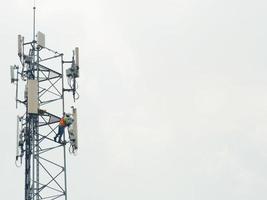 Technicians are servicing telephone towers. Working on high ground requires safety precautions. photo