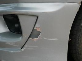 Scratches on the car after an accident damage to the front bumper. photo