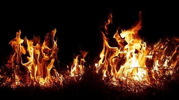 Haystack fires at night in arid areas The ash erupted and the wind was very dangerous. ashes red as hell. photo