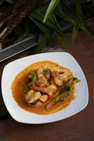 Stir fried shrimp with curry paste in a white plate. photo