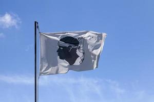 Corsican flag waving on its flagpole photo