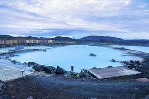 Beautiful view of natural blue lagoon in geothermal spa against cloudscape photo