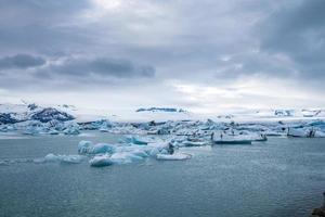 Beautiful icebergs floating in Jokulsarlon glacier lagoon in polar climate photo