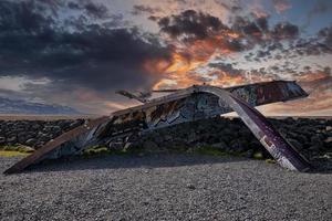 Ruins of damaged Gigjukvisl bridge at Skeidararsandur against dramatic sky photo