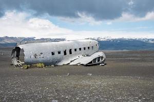 Abandoned military aircraft wreck at black sand beach in Solheimasandur photo