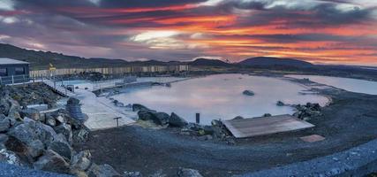 Panoramic view of natural blue lagoon in geothermal spa against dramatic sky photo