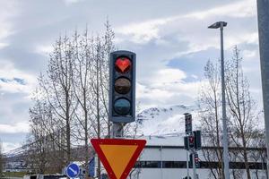 Creative heart shaped stop light in traffic signal at city against sky photo