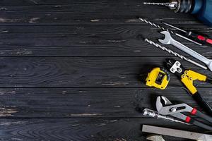 Set of working tools on wooden rustic background. Top view. Copy space photo