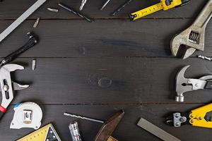 Set of working tools on wooden rustic background. Top view. Copy space photo