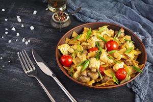 Stir fry farfalle pasta with vegetables, cauliflower and mushrooms photo