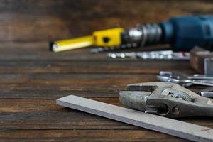 Set of working tools on wooden rustic background photo