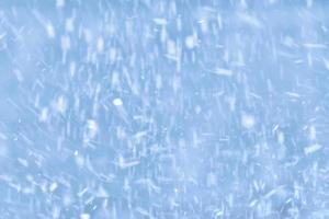 falling snow on a blue background photo