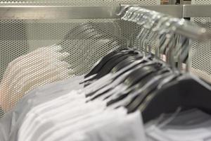 hangers with clothes in the store photo