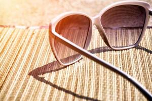 glasses on the beach sand photo