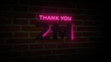 gracias 2 millones de seguidores letrero luminoso de neón realista en la animación de la pared de ladrillos video