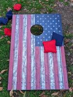Red white and blue cornhole game with stars to look like an American Flag with bean bags photo