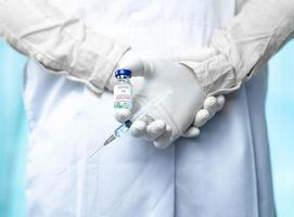 close up doctor holding syringe to injection to the patient in medical. Covid-19 or coronavirus vaccine. virus removal and prevention concept photo