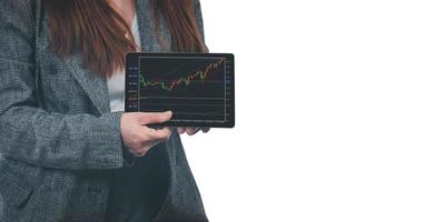 A young businesswoman holds a tablet with a graph showing the ups and downs of her stock. Concept of doing an online business called stock trading that anyone can do if it is learned