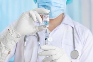 close up doctor holding syringe to injection to the patient in medical. Covid-19 or coronavirus vaccine. virus removal and prevention concept photo