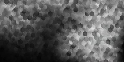 Dark gray vector backdrop with a batch of hexagons.