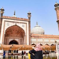 Delhi, India - April 15, 2022 - Unidentified Indian tourists visiting Jama Masjid during Ramzan season, in Delhi 6, India. Jama Masjid is the largest and perhaps the most magnificent mosque in India photo