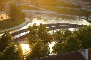 Cityscape view from Gediminas castle on the financial district with modern buildings, river and bridge during the sunset in Vilnius, Lithuania. photo