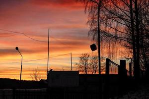 Industrial city part silhouettes on beautiful bright colors of sunset over city photo