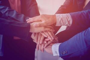 The hands of a group of businessmen shake hands to reach an agreement in a company meeting. photo