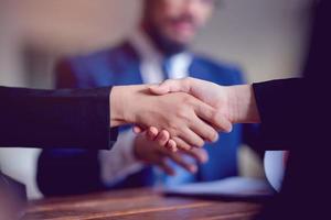 The hands of a group of businessmen shake hands to reach an agreement in a company meeting. photo