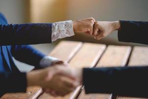 The hands of a group of businessmen shake hands to reach an agreement in a company meeting. photo