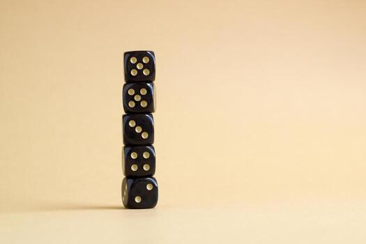 Stack of gaming dice with copy space on beige background. Concept for games, game board, role playing game, risk, chance, good luck or gambling. Image top view. photo