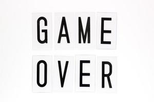 Game over text on white background. Concept for banners, web pages, games, presentation. Image top view photo