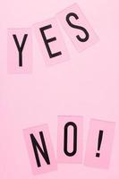 YES and NO words with copy space on pink background. Pastel concept for web, presentation, banners or motivation. Top view image photo