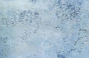 Abstract texture of decorative plaster. Grunge background of stucco texture. Blue grained surface photo