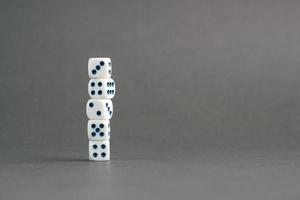 Stack of gaming dice with copy space on gray background. Concept for games, game board, role playing game, risk, chance, good luck or gambling. Image top view photo