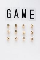 Female hand holds gaming dice on white background. Concept with GAME text for presentation, banners, game board, role playing game, risk, chance, good luck. Top view image. Close-up photo