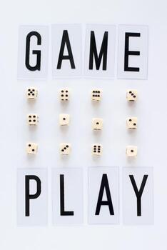 GAME PLAY words and gaming dice in row on white background. Concept for banners, web pages, games, game board, presentation. Top view photo
