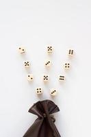 Set of gaming dice rolled out of leather bag on white background. Concept with copy space for games, game board, role playing game, risk, chance, good luck or gambling. Top view. Close-up photo