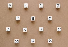 Gaming dice pattern on brown background in flat lay style. Concept with copy space for games, game board, role playing game, risk, chance, good luck or gambling. Toned image top view. Close-up photo