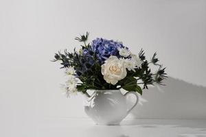 Flower bouquet in a teapot photo