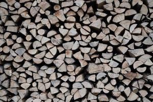 Gray and brown chopped stacked firewood background photo