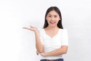 Portrait Asian woman is smiling and shows her hands to present something on the white background. photo