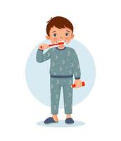 cute little boy in pajamas brushing teeth with toothpaste doing daily routine hygiene activity in bathroom vector