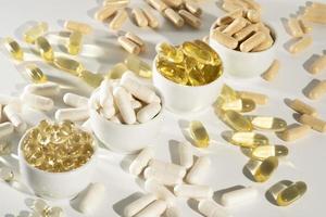 Food supplement oil filled fish oil, vitamin D, omega 3, omega 6, vitamin A, vitamin E, flaxseed oil. photo