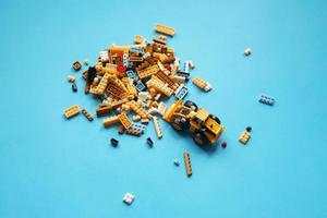 BANGKOK, THAILAND - june 13, 2022  Group of lego toys and bulldozer on blue background. photo